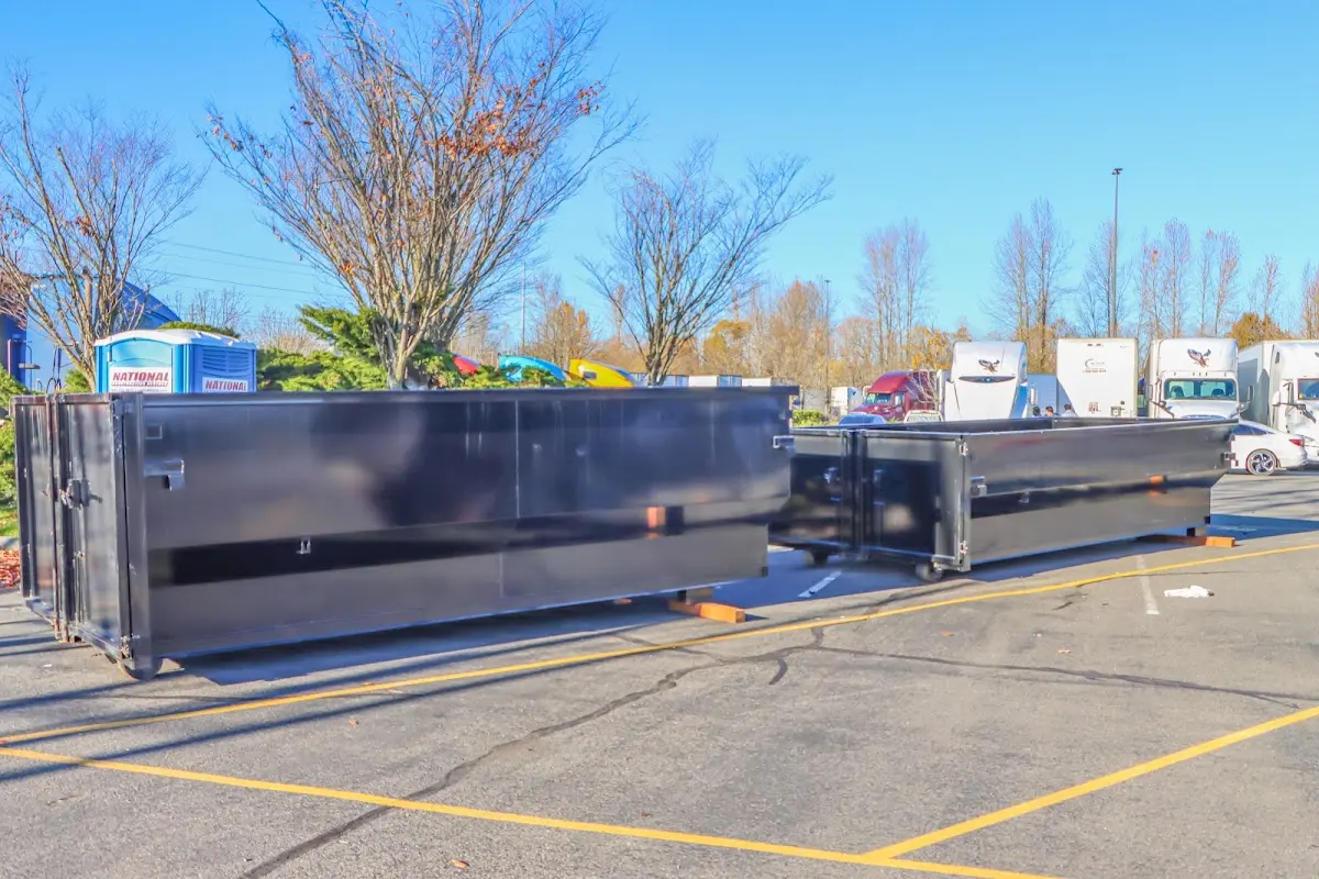 Professional dumpster rental service with roll-off container on residential driveway in Fultondale
